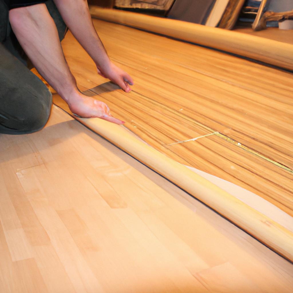 Person installing bamboo flooring at home