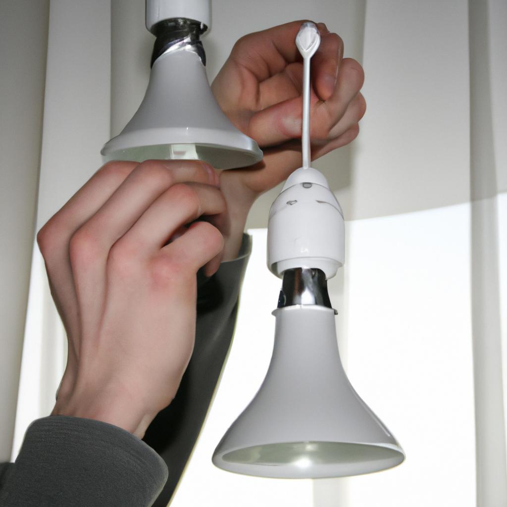 Person installing energy-efficient lightbulbs