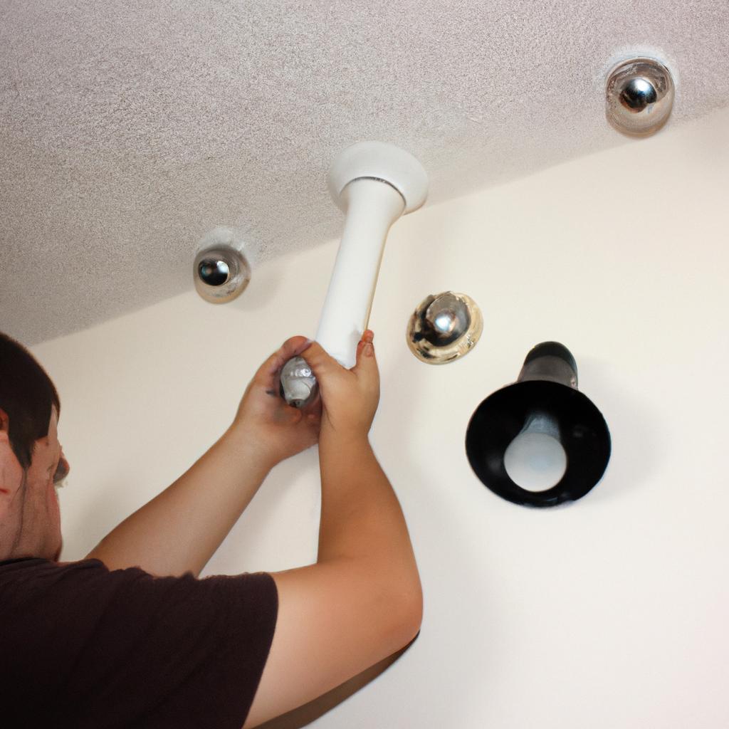 Person installing lighting fixtures at home