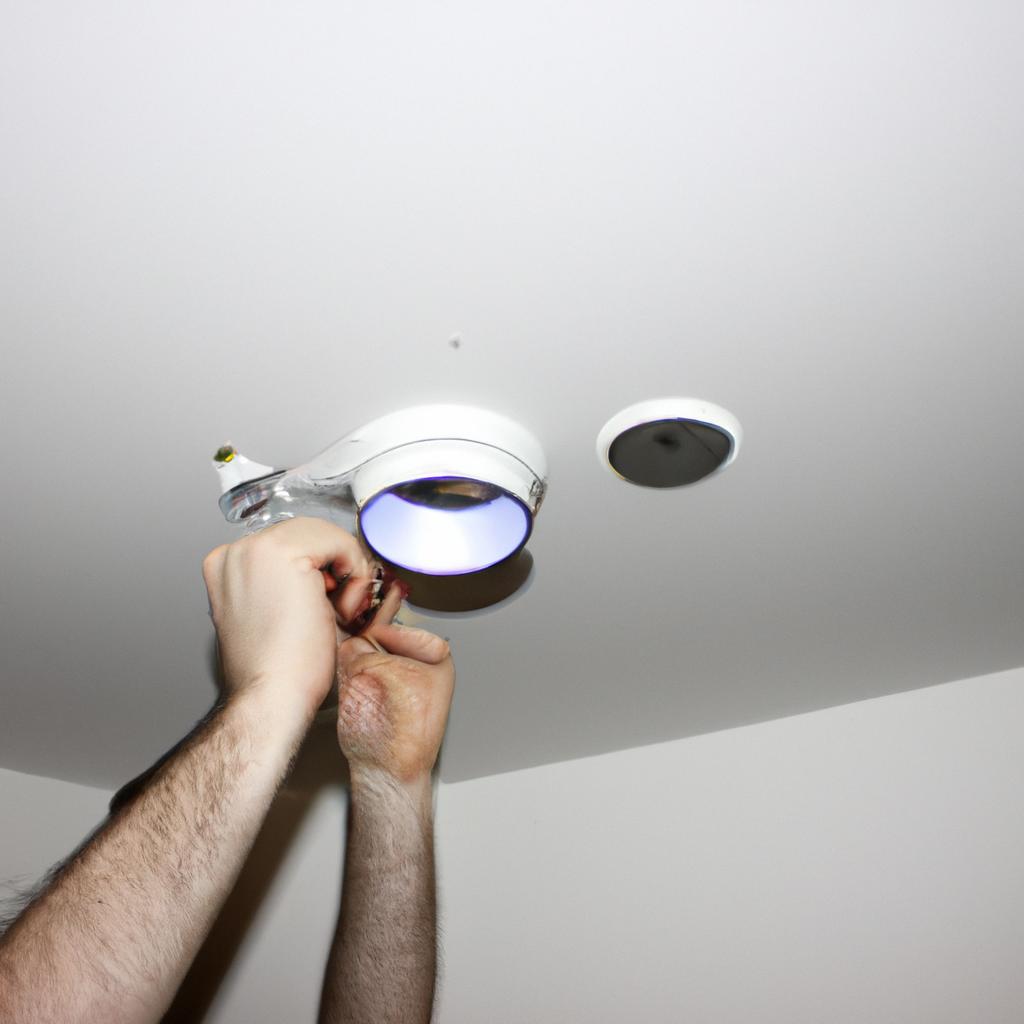 Person installing smart lighting fixtures
